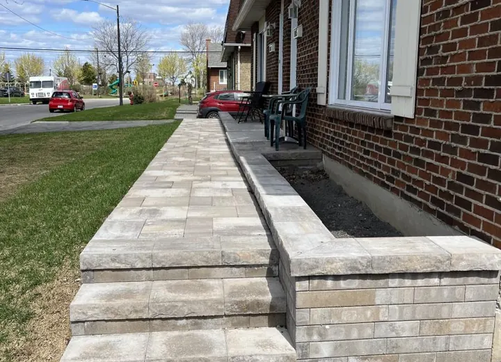 Terrassement effectué sur la rue Bisson , Québec, QC. Travaux de muret dalles de béton et marches en pavé unis. King Bitume