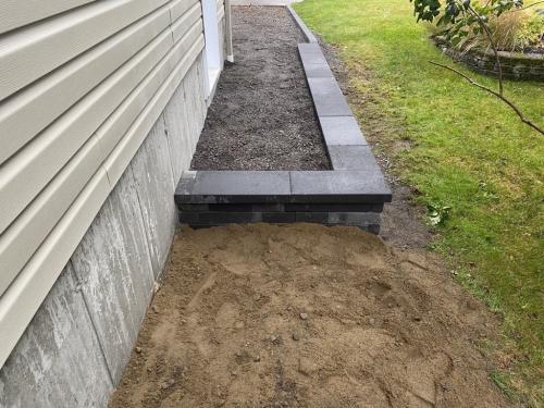 Travaux de construction de muret en dalle dans la Ville de Québec.